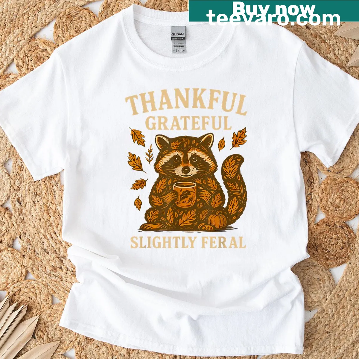 Funny raccoon graphic with text 'Thankful Grateful Slightly Feral' for autumn wear — on a men's t-shirt