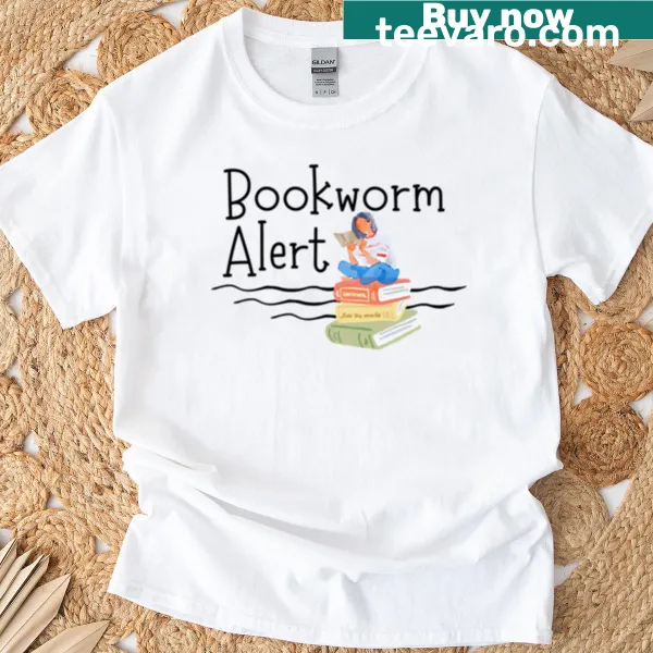 Cute t-shirt featuring a girl reading on a pile of books