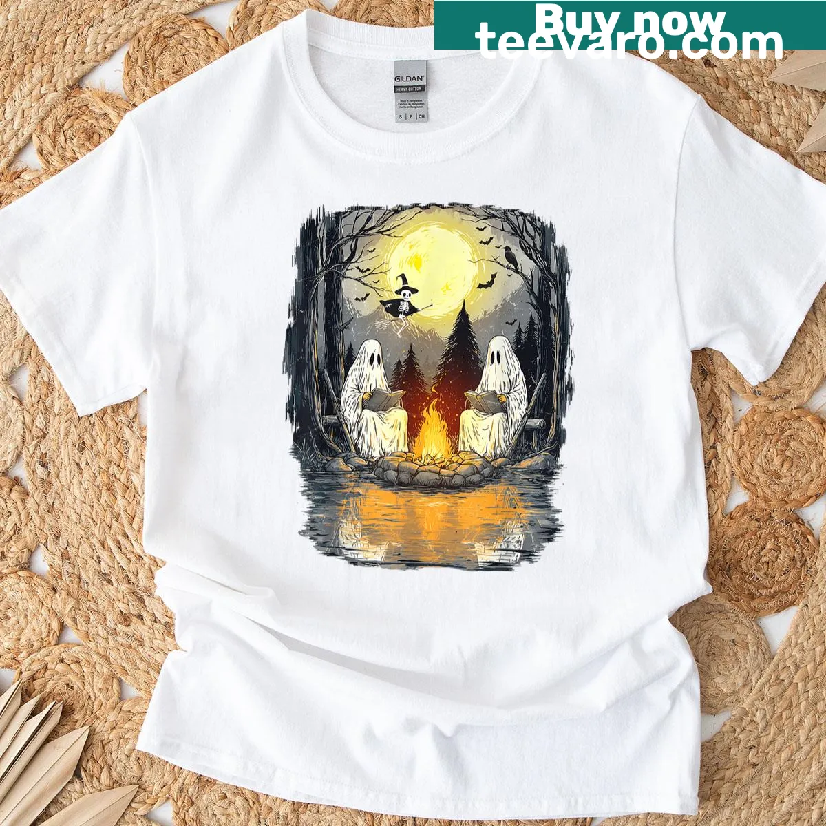 Friendly ghost reading a book by a campfire for Halloween t-shirt — on a men's t-shirt