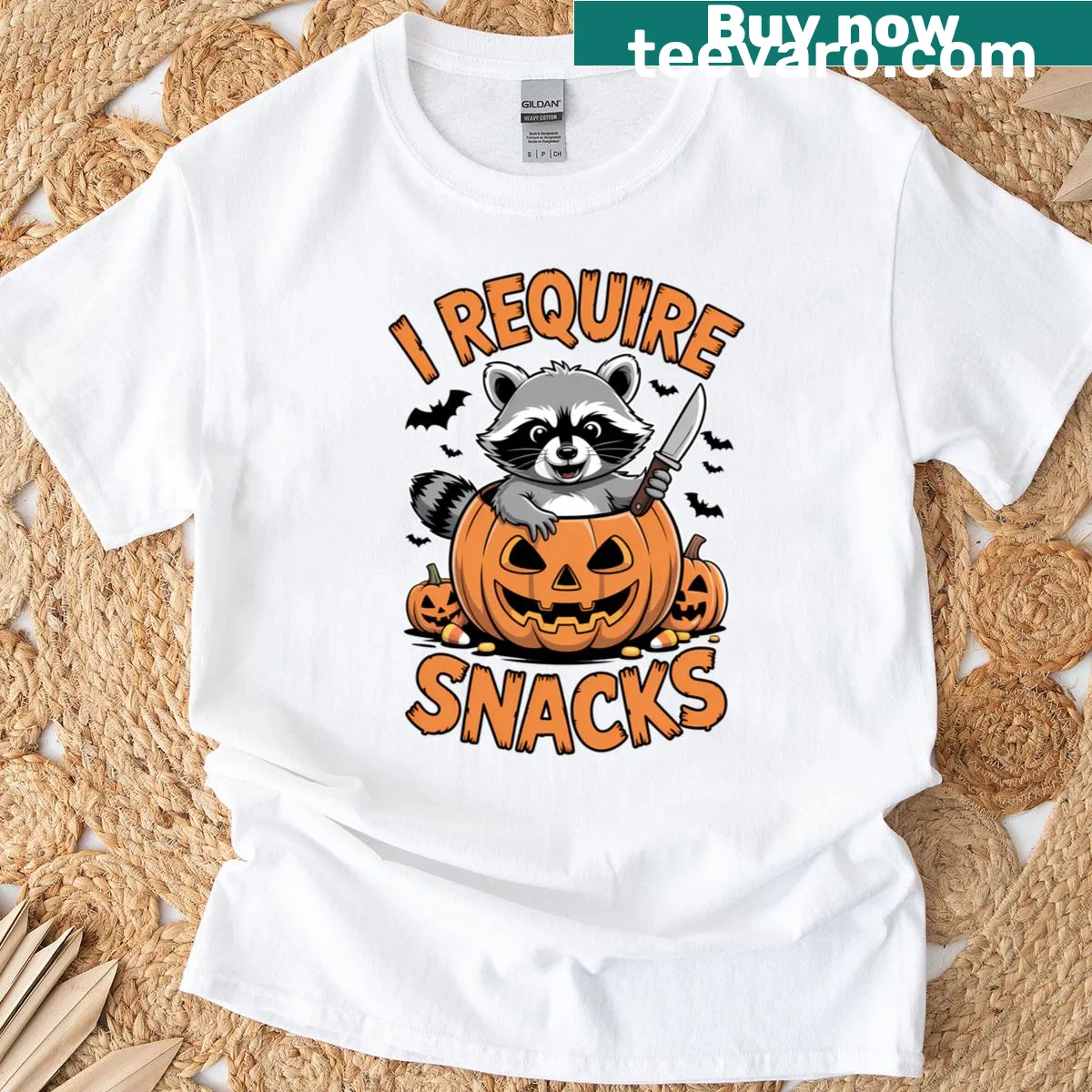 Funny Halloween t-shirt featuring a raccoon with a pumpkin saying 'I Require Snacks' — on a men's t-shirt