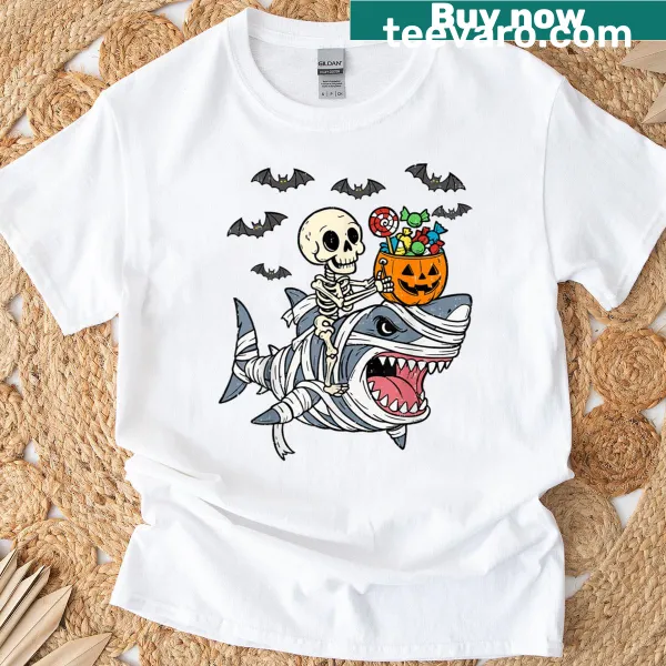 Cartoon skeleton riding a mummy shark on a Halloween kids T-shirt