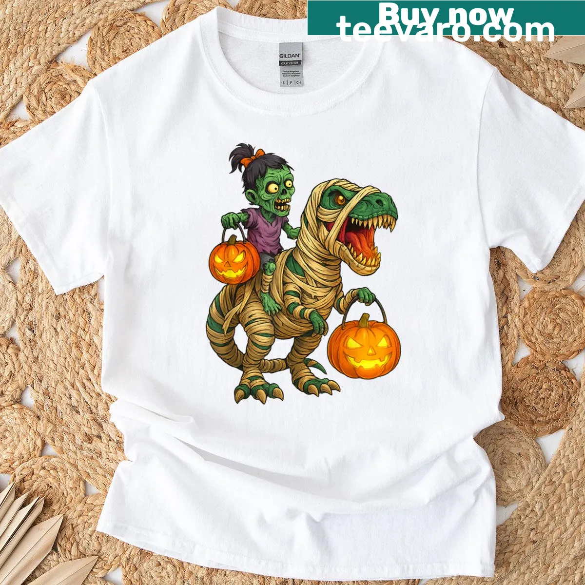 Cartoon of a zombie girl riding a mummy T. Rex for Halloween. — on a men's t-shirt