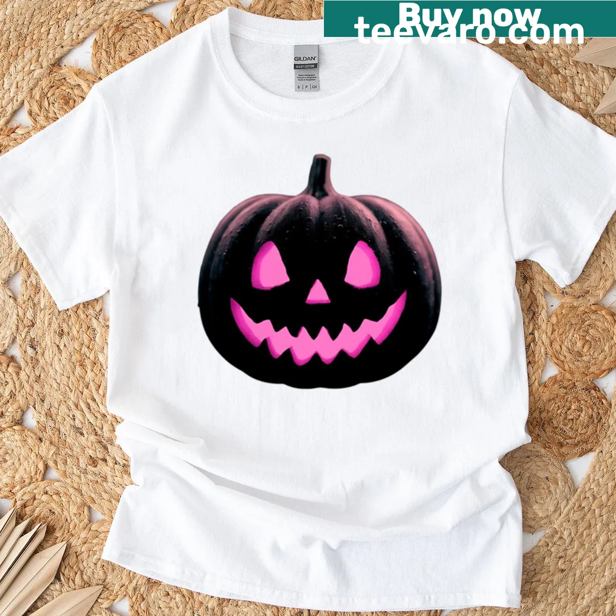 Minimalist Halloween t-shirt with a glowing pink Jack O' Lantern design — on a men's t-shirt