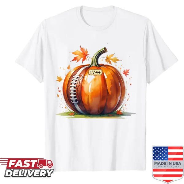 Shirt featuring a pumpkin graphic with football elements