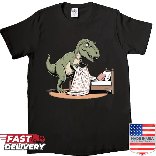 Cartoon shirt featuring a T-rex struggling to make a bed