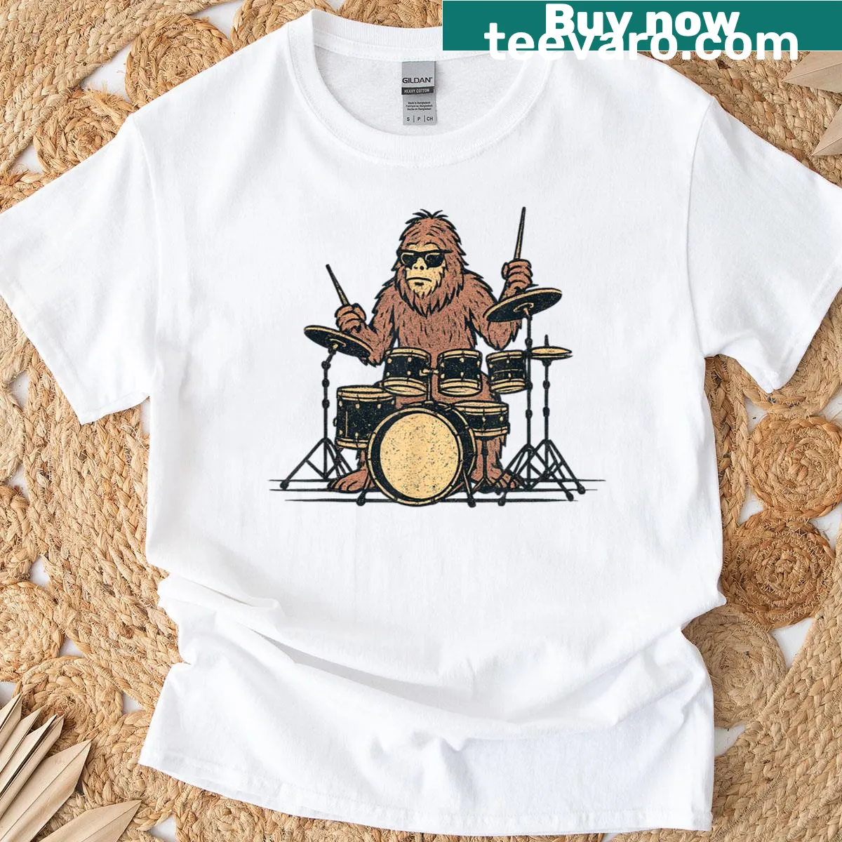 Funny T-shirt featuring Sasquatch playing drums in vintage style — on a men's t-shirt