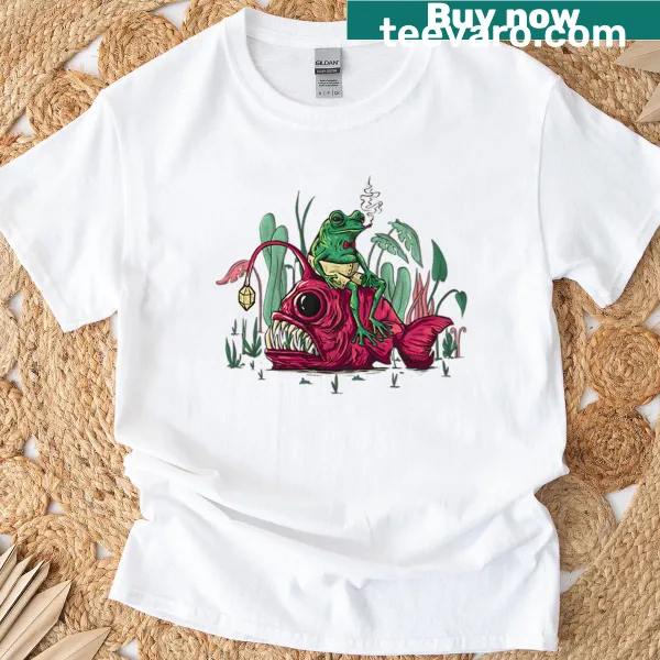 T-shirt featuring a whimsical illustration of a fish with a frog