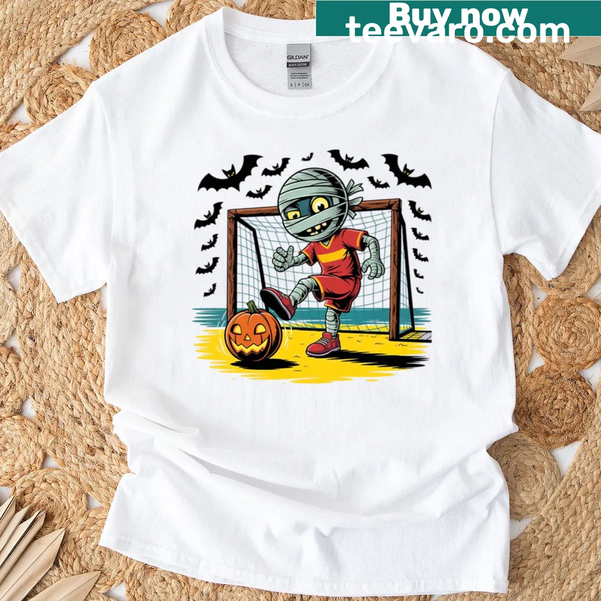 Cartoon neon mummy playing soccer with a glowing pumpkin ball — on a men's t-shirt