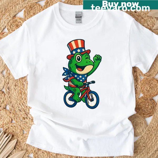 Cartoon frog riding a bike on a patriotic-themed T-shirt