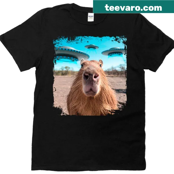 Capybara encountering a UFO in a playful illustration on a t-shirt