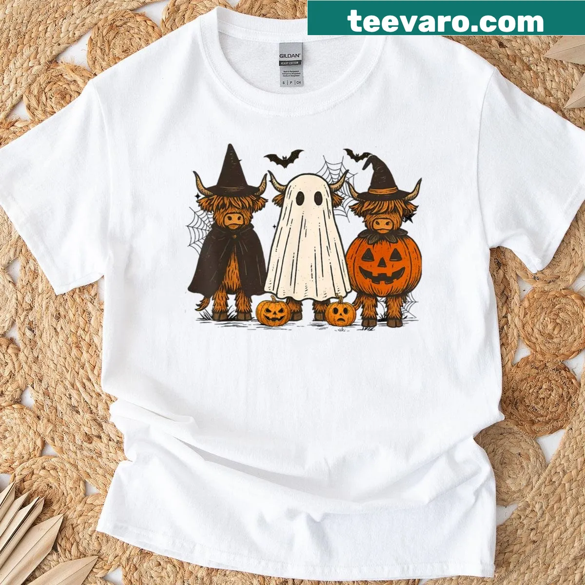 Cute Halloween T-shirt featuring a Highland cow and pumpkins — on a men's t-shirt