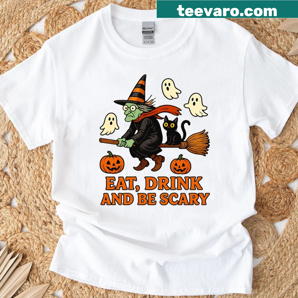 Whimsical Halloween T-shirt featuring a witch and ghost cats — on a men's t-shirt