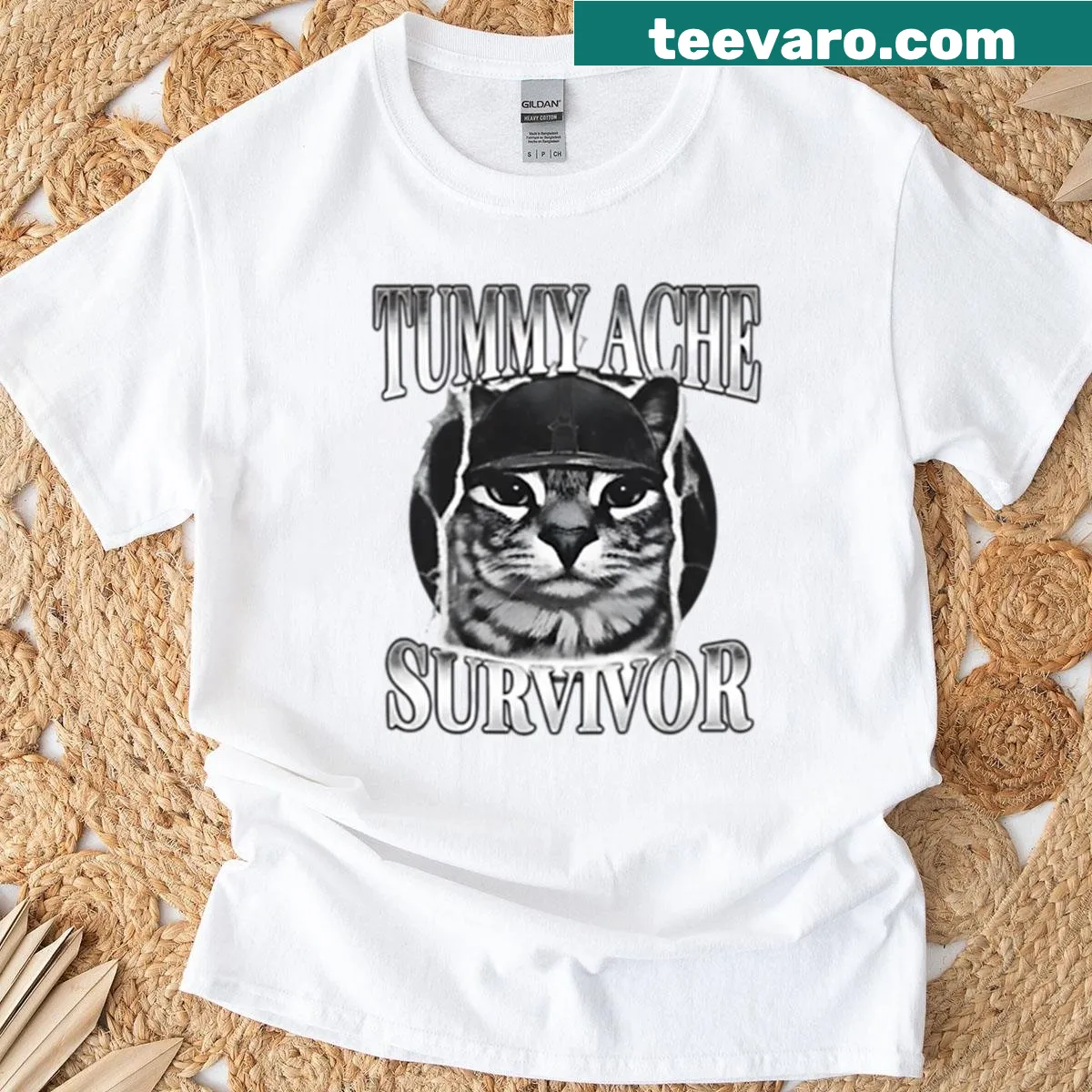 Humorous illustration of a cat as a warrior, declaring tummy ache survivor. — on a men's t-shirt