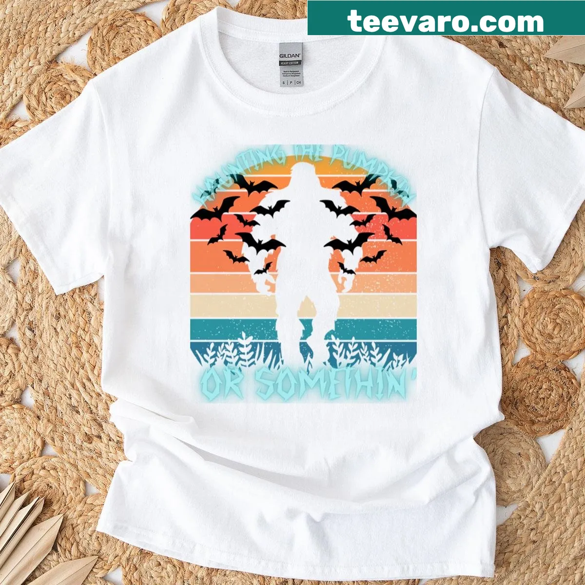 Funny Bigfoot graphic on oversized T-shirt with pumpkins and sunset — on a men's t-shirt