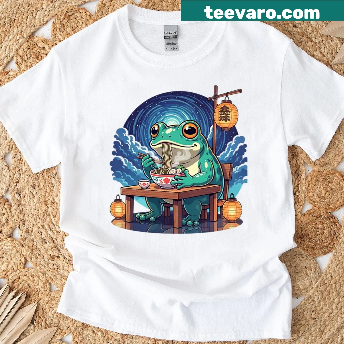 Cute frog enjoying ramen under the stars in a whimsical illustration. — on a men's t-shirt