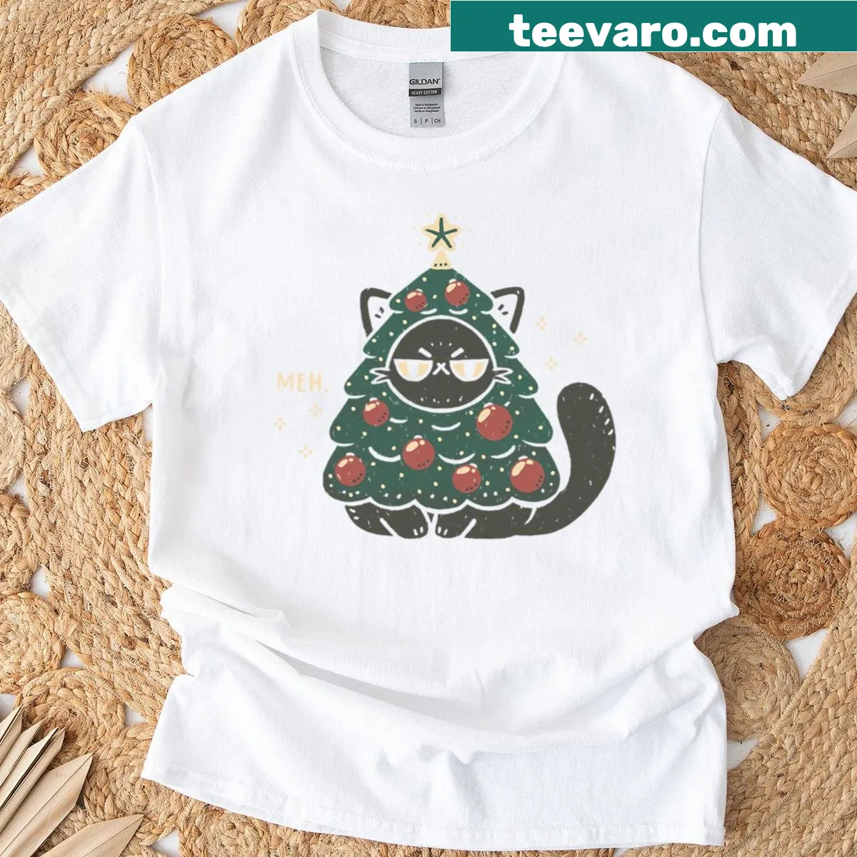 Oversized t-shirt featuring a cat dressed as a Christmas tree with playful ornaments. — on a men's t-shirt
