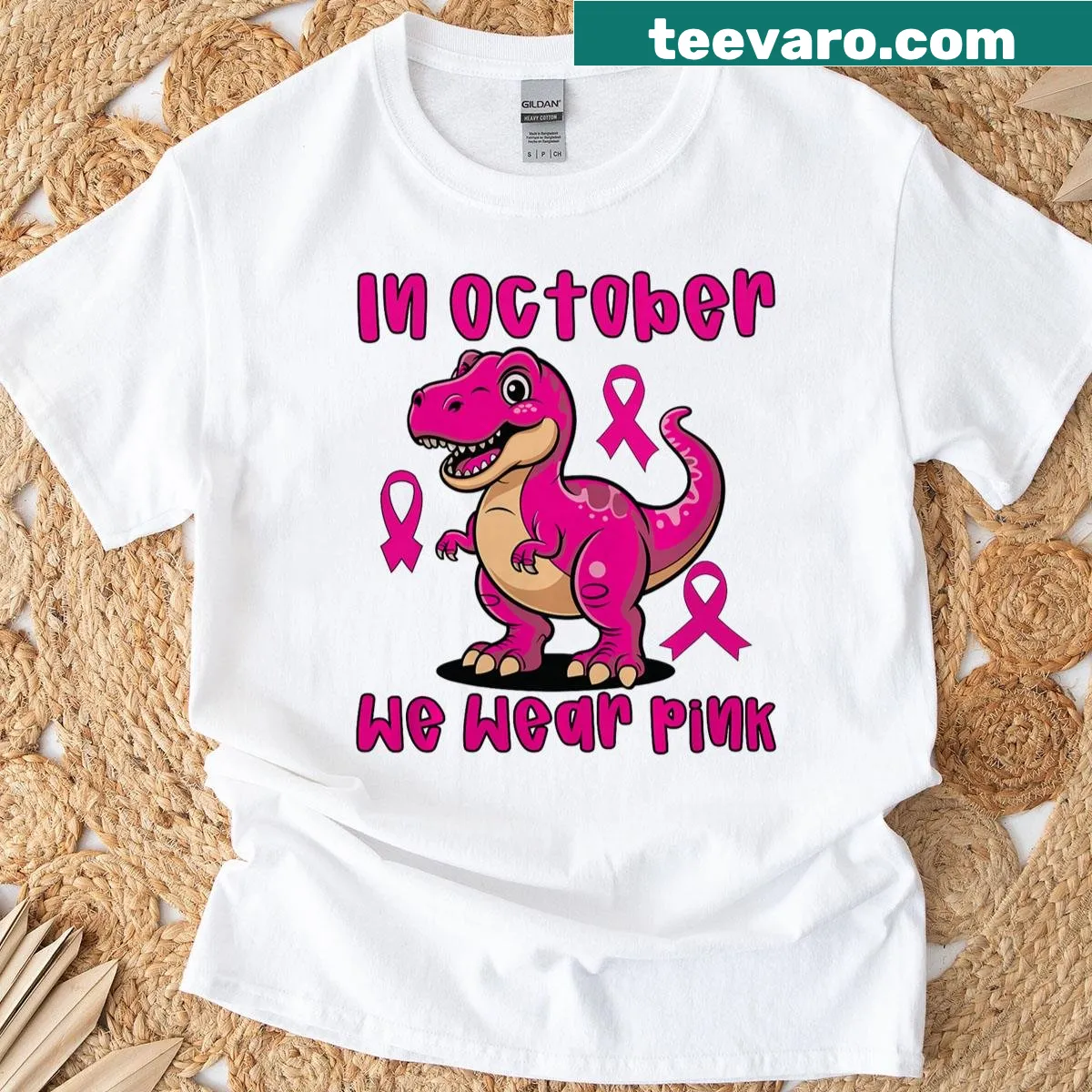 Playful T-rex wearing a pink ribbon for breast cancer awareness — on a men's t-shirt