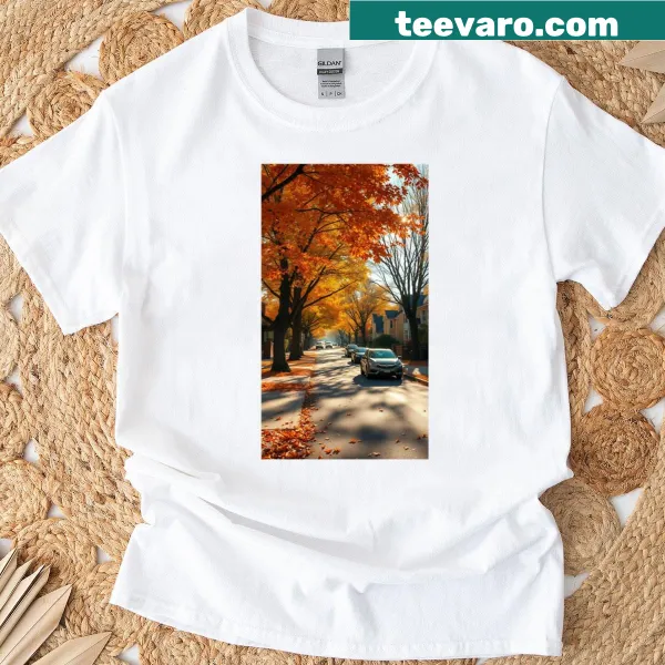 T-shirt depicting an autumn street scene with golden leaves