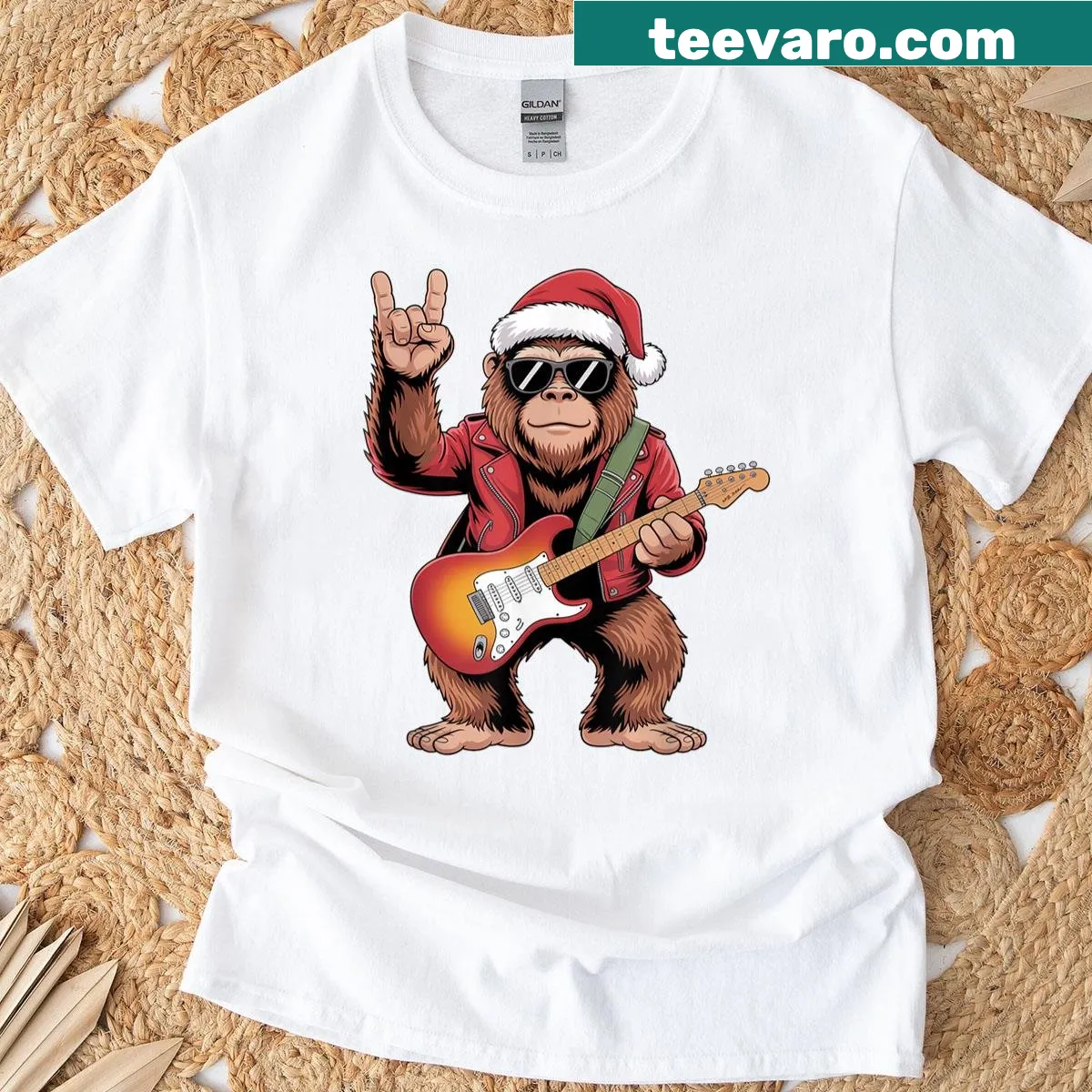 Bigfoot Santa playing guitar in a Christmas-themed T-shirt — on a men's t-shirt