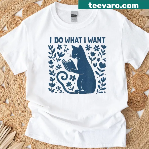 Vintage T-shirt featuring a cat reading a book surrounded by flowers