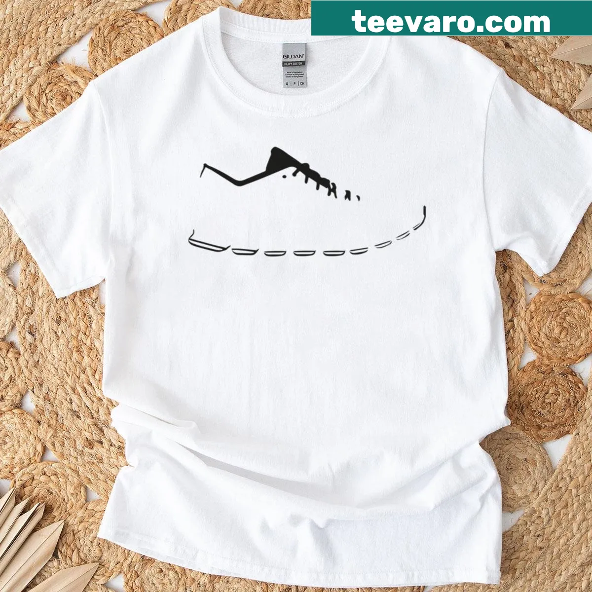 Minimalist sneaker line drawing on casual T-shirt — on a men's t-shirt