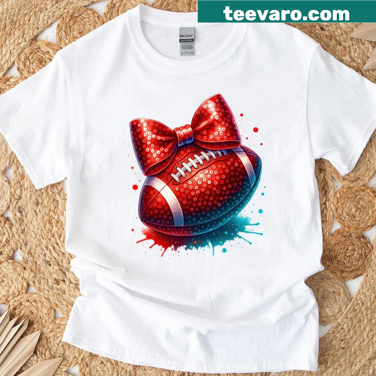 Illustrative t-shirt featuring a sparkly red football with a bow and paint splashes. — on a men's t-shirt