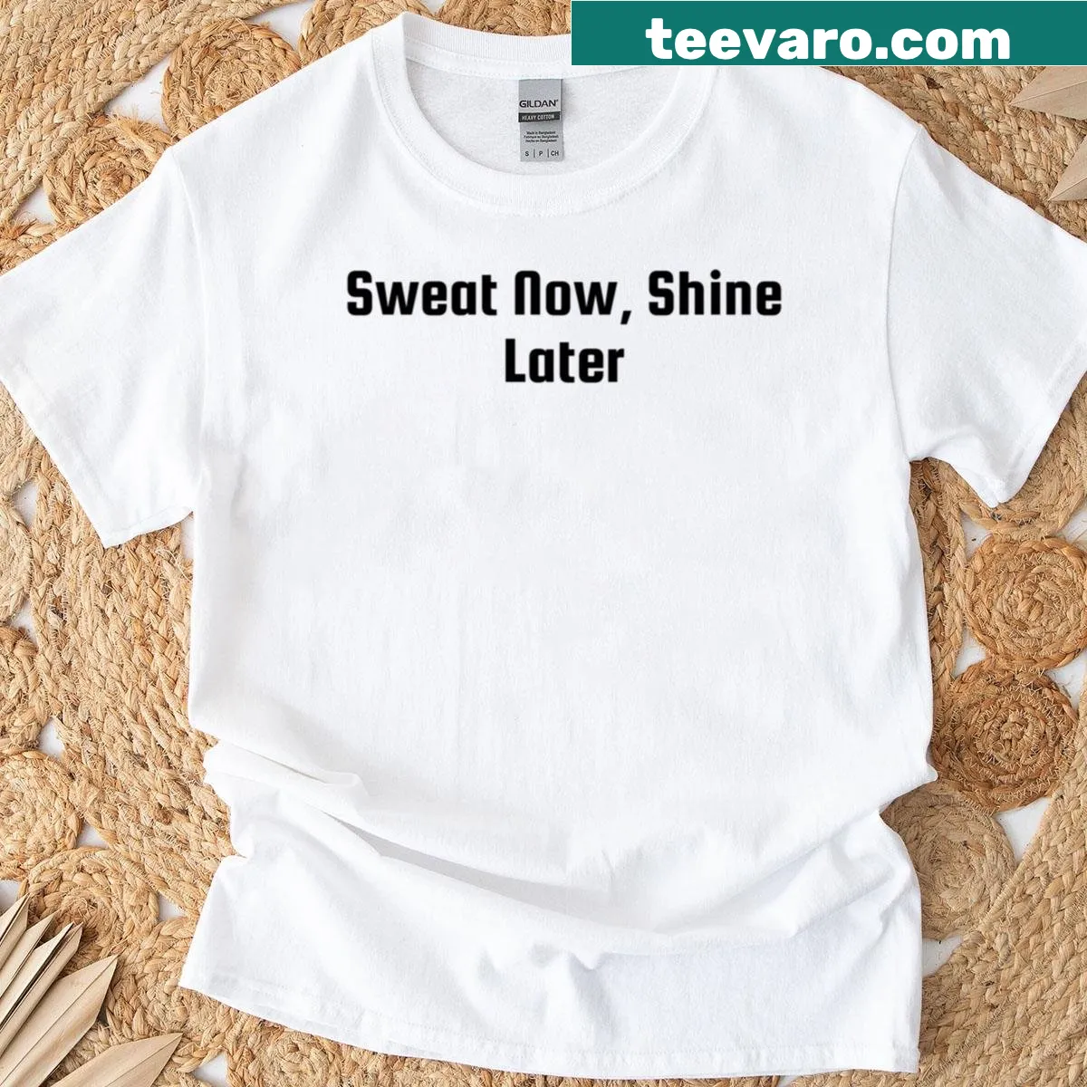 Motivational typography saying 'Sweat Now Shine Later' on a t-shirt. — on a men's t-shirt