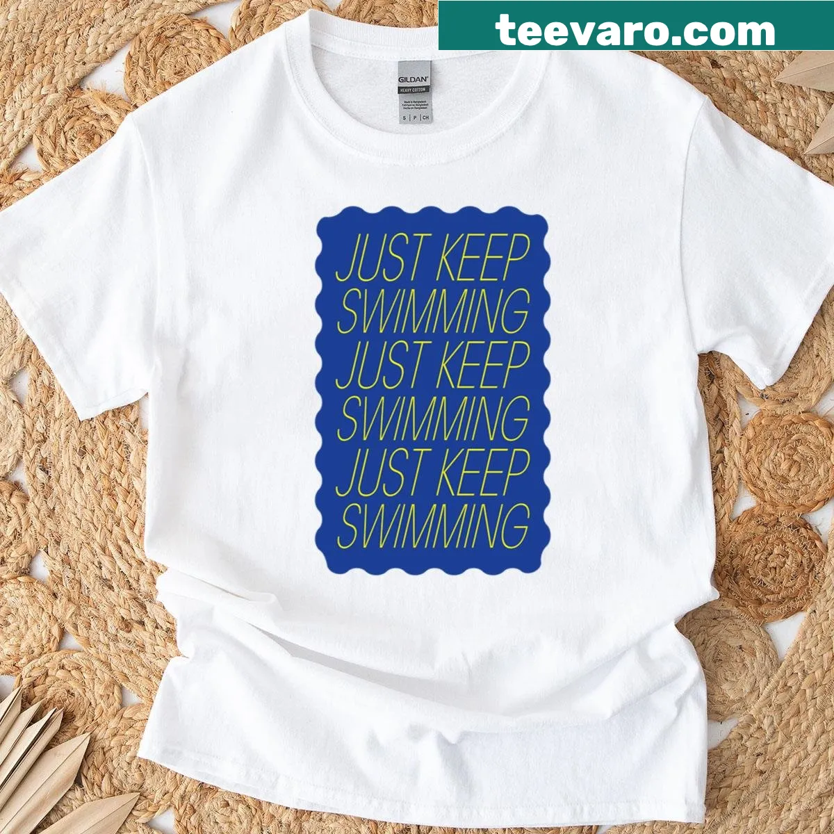Typography t-shirt featuring the motivational quote Just Keep Swimming in blue and yellow — on a men's t-shirt