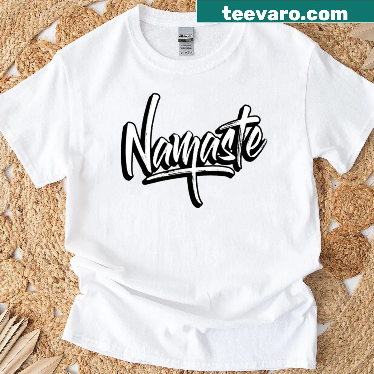 Minimalist Namaste logo shirt in handwritten style — on a men's t-shirt