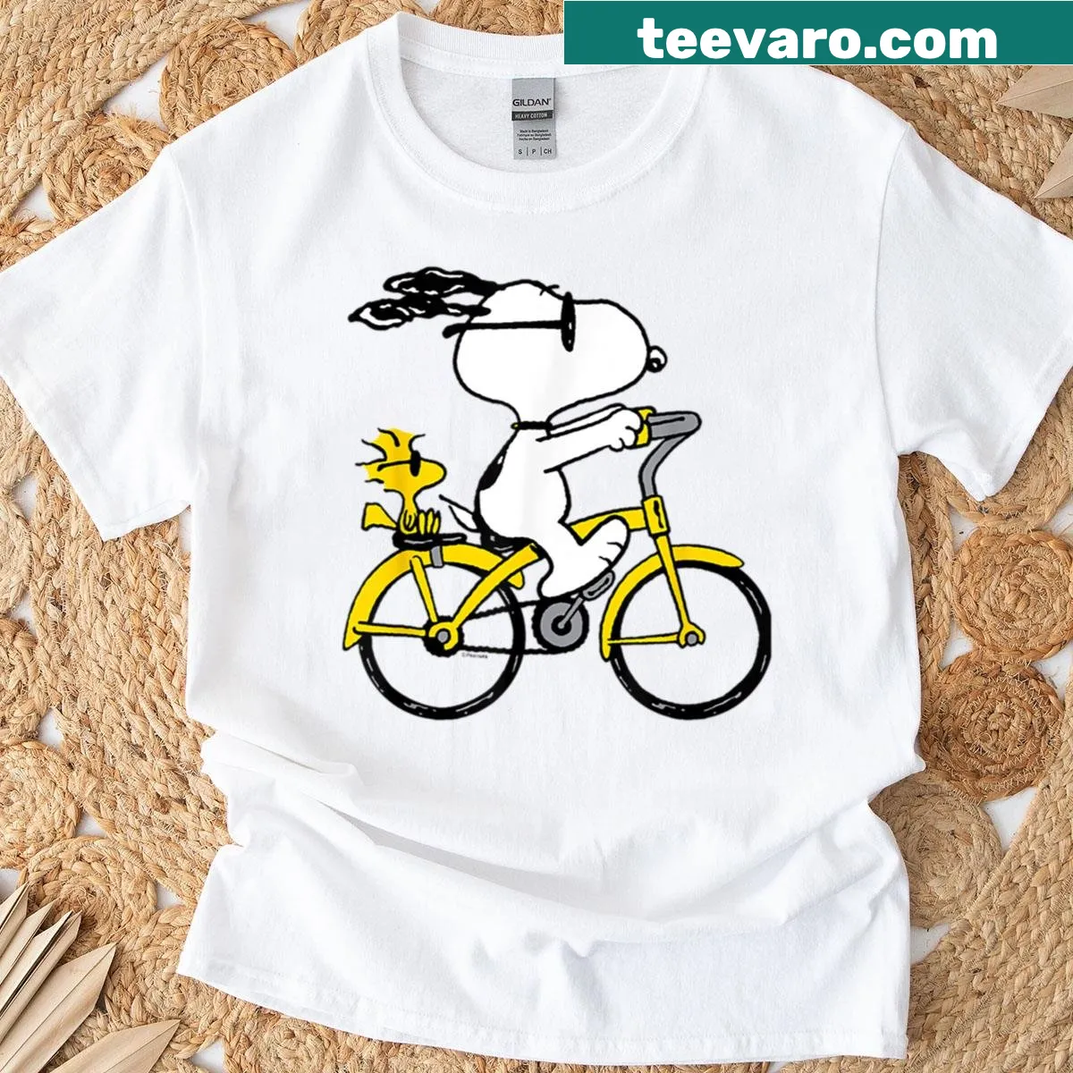Snoopy and Woodstock riding a bike illustration on T-shirt — on a men's t-shirt