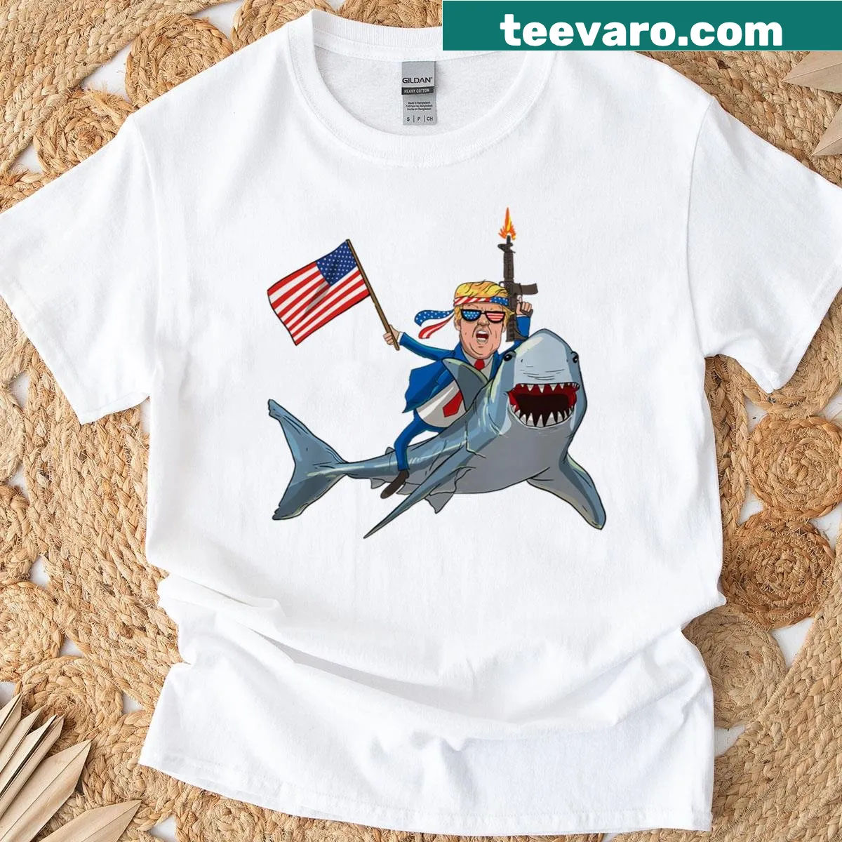 Cartoon graphic of Trump riding a shark with patriotic themes — on a men's t-shirt