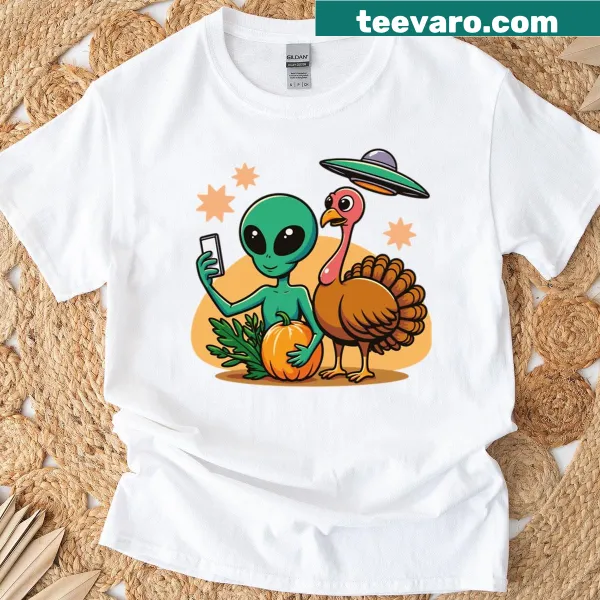 Whimsical alien turkey taking a selfie on a shirt.