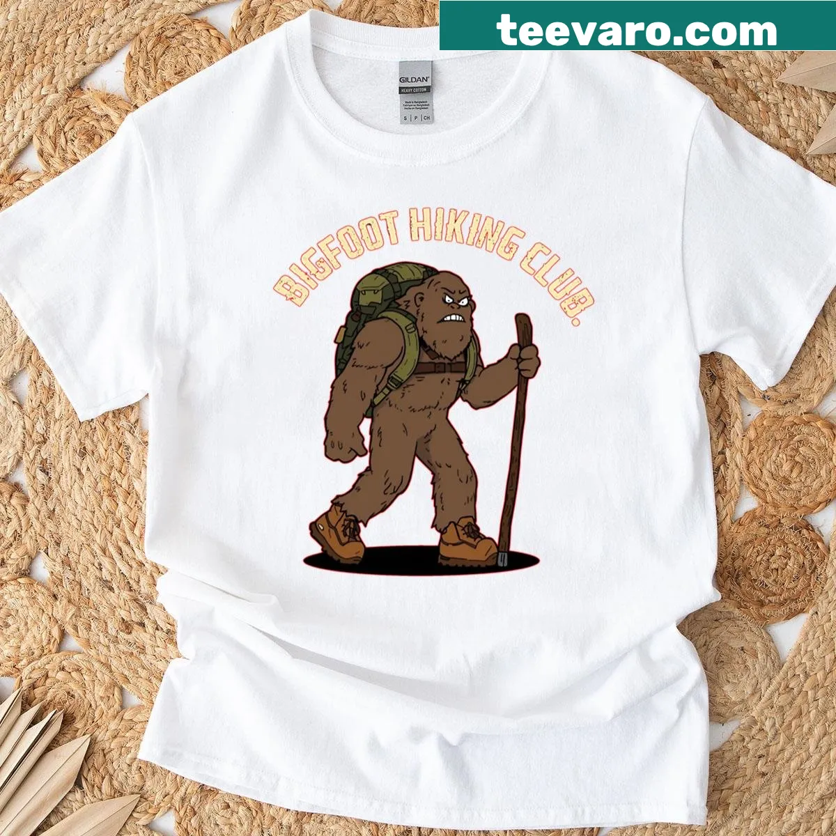 Playful Bigfoot Hiking Club T-shirt with illustrations and text — on a men's t-shirt