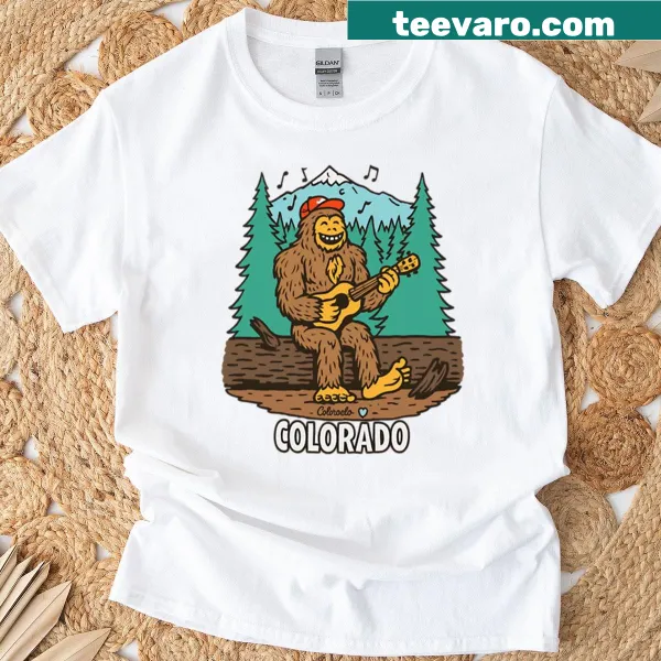 T-shirt featuring a whimsical Bigfoot in a Colorado mountain scene