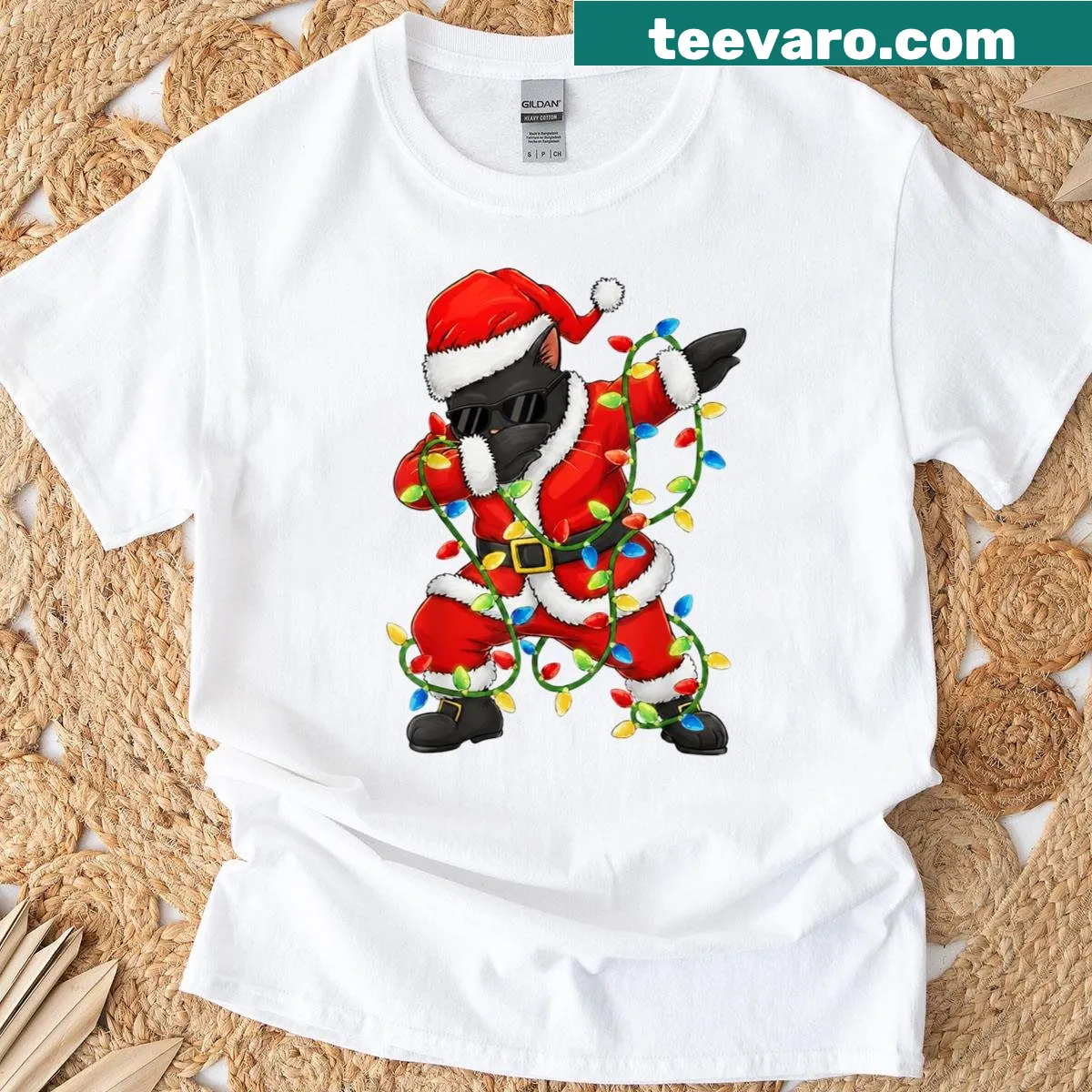 Funny Christmas shirt featuring a dabbing black cat in a Santa outfit. — on a men's t-shirt