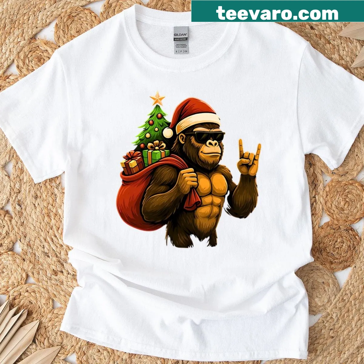 Bigfoot wearing a Santa hat carrying a Christmas tree t-shirt — on a men's t-shirt