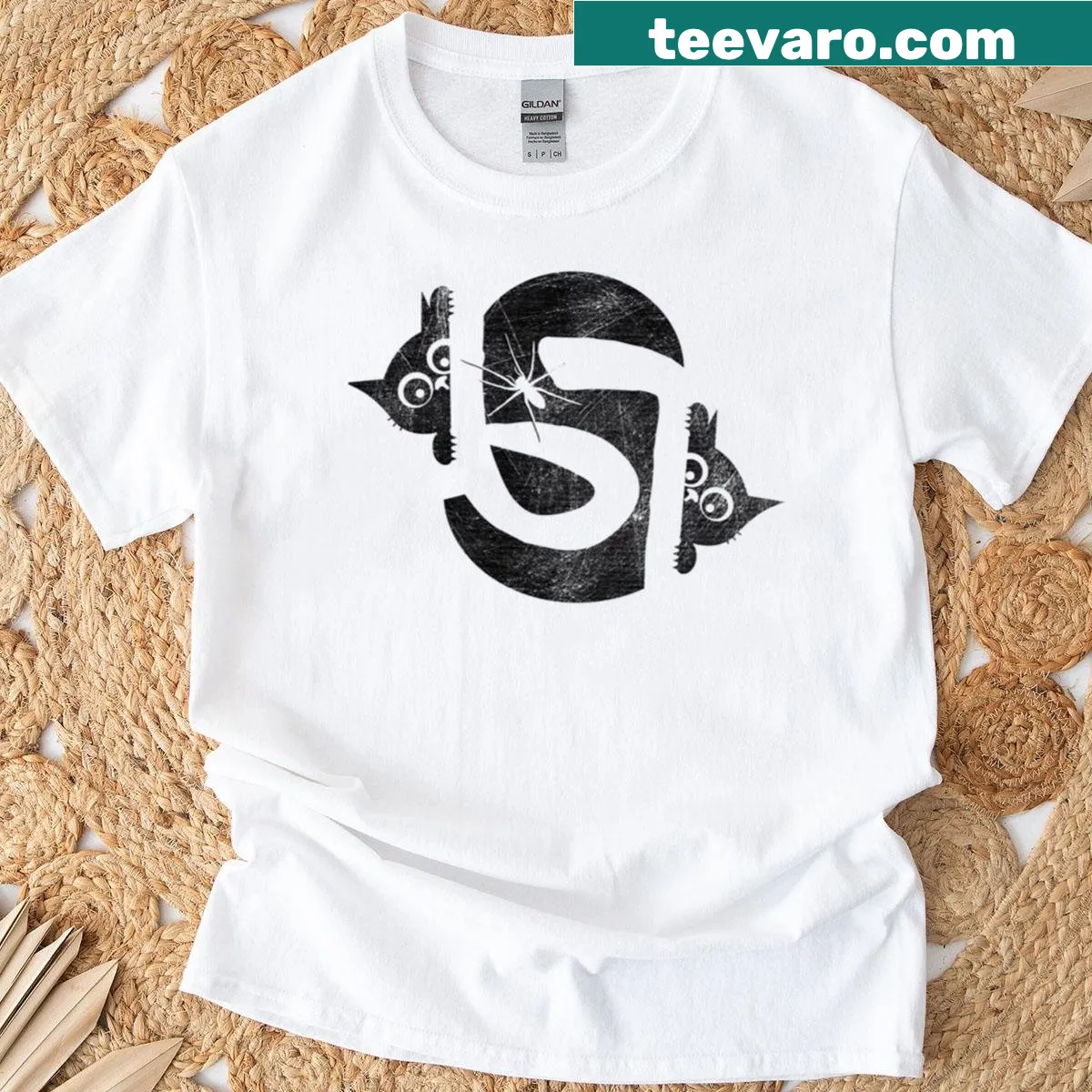 Optical illusion T-shirt featuring two cats in negative space — on a men's t-shirt