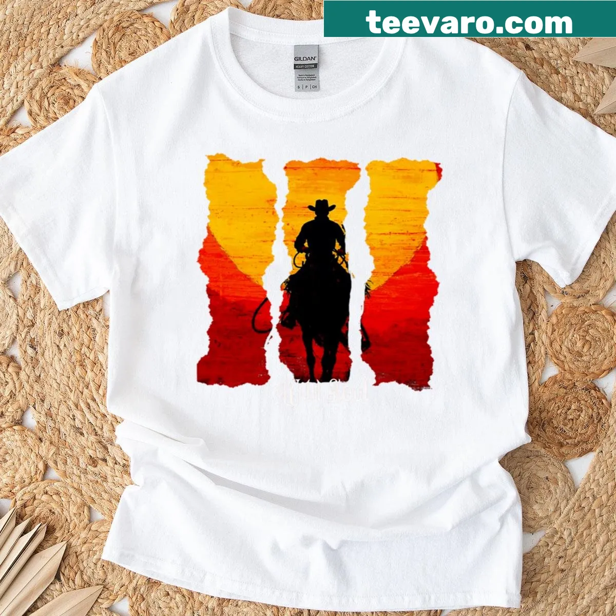 Vintage T-shirt depicting a cowboy silhouette at sunset — on a men's t-shirt