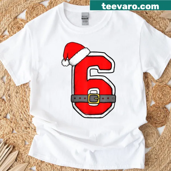 T-shirt featuring a cartoon '6' birthday design with Santa hat