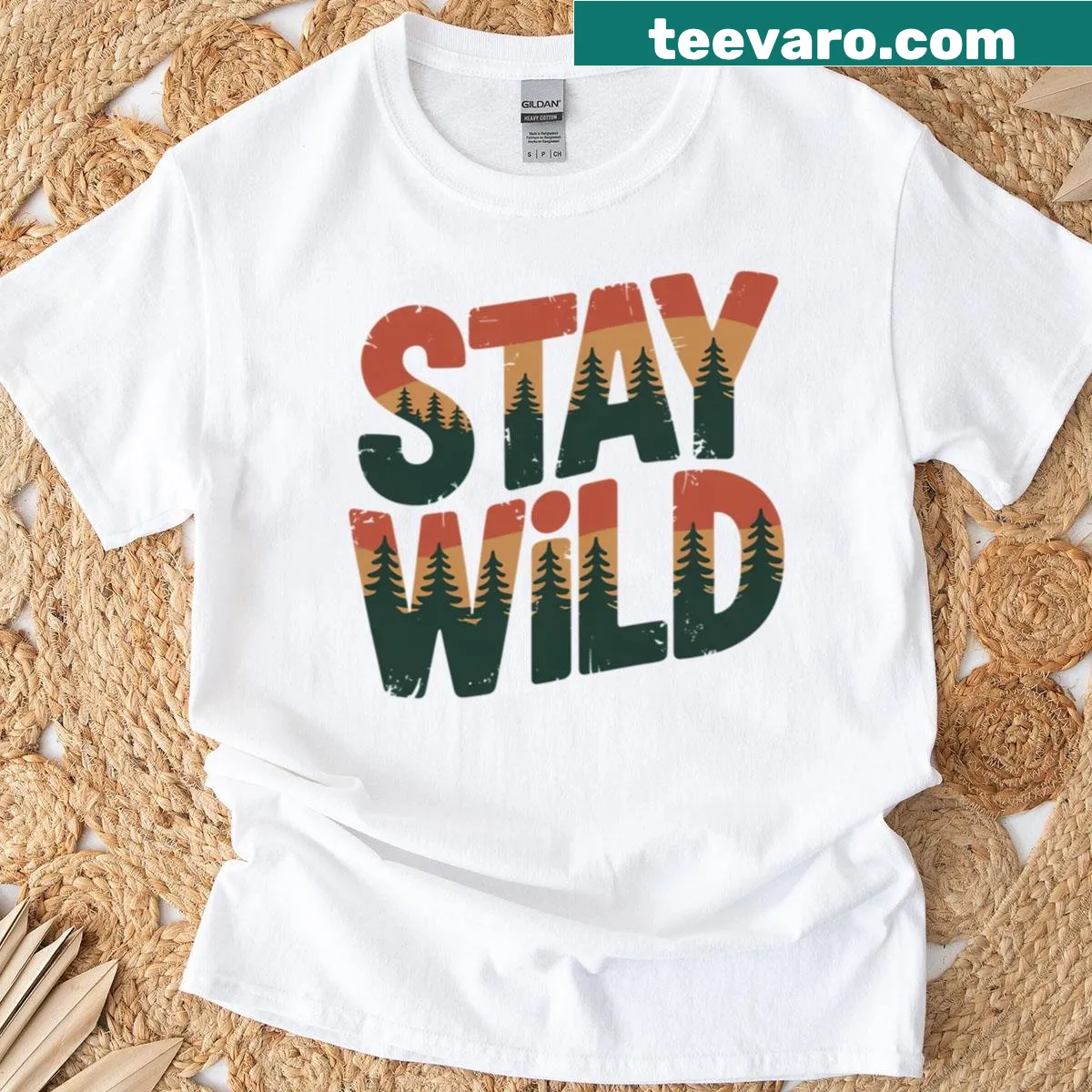 Oversized T-shirt with 'Stay Wild' typography and forest pine trees — on a men's t-shirt