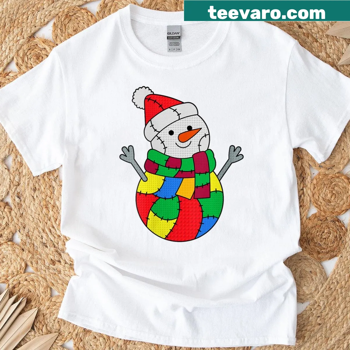 Playful patchwork snowman graphic on a Christmas-themed t-shirt — on a men's t-shirt