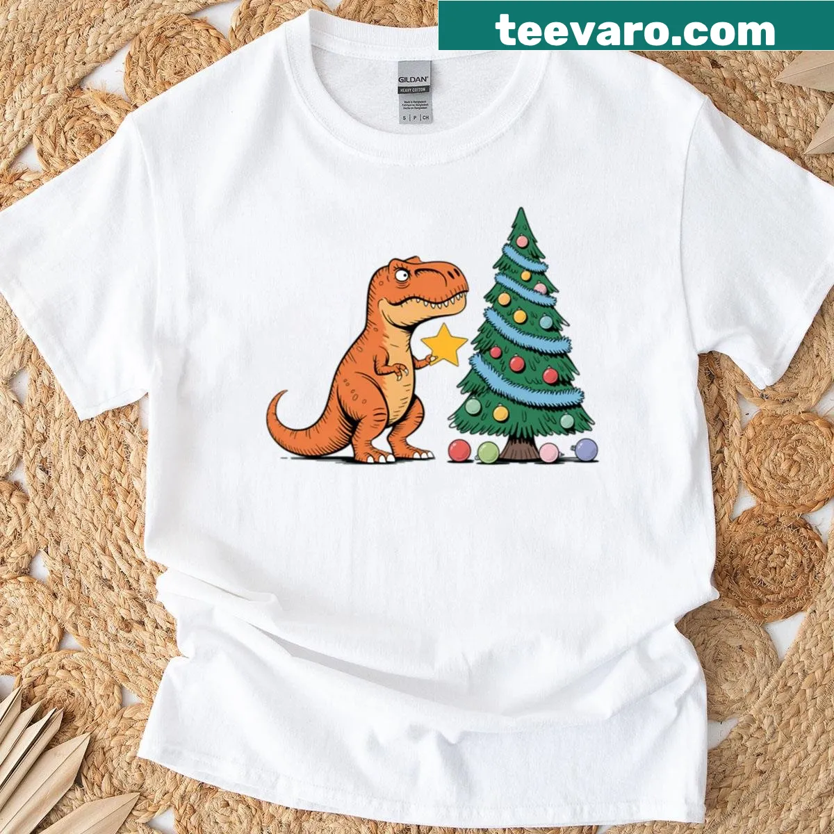 Cartoon T-rex decorating a Christmas tree on a festive oversized T-shirt — on a men's t-shirt