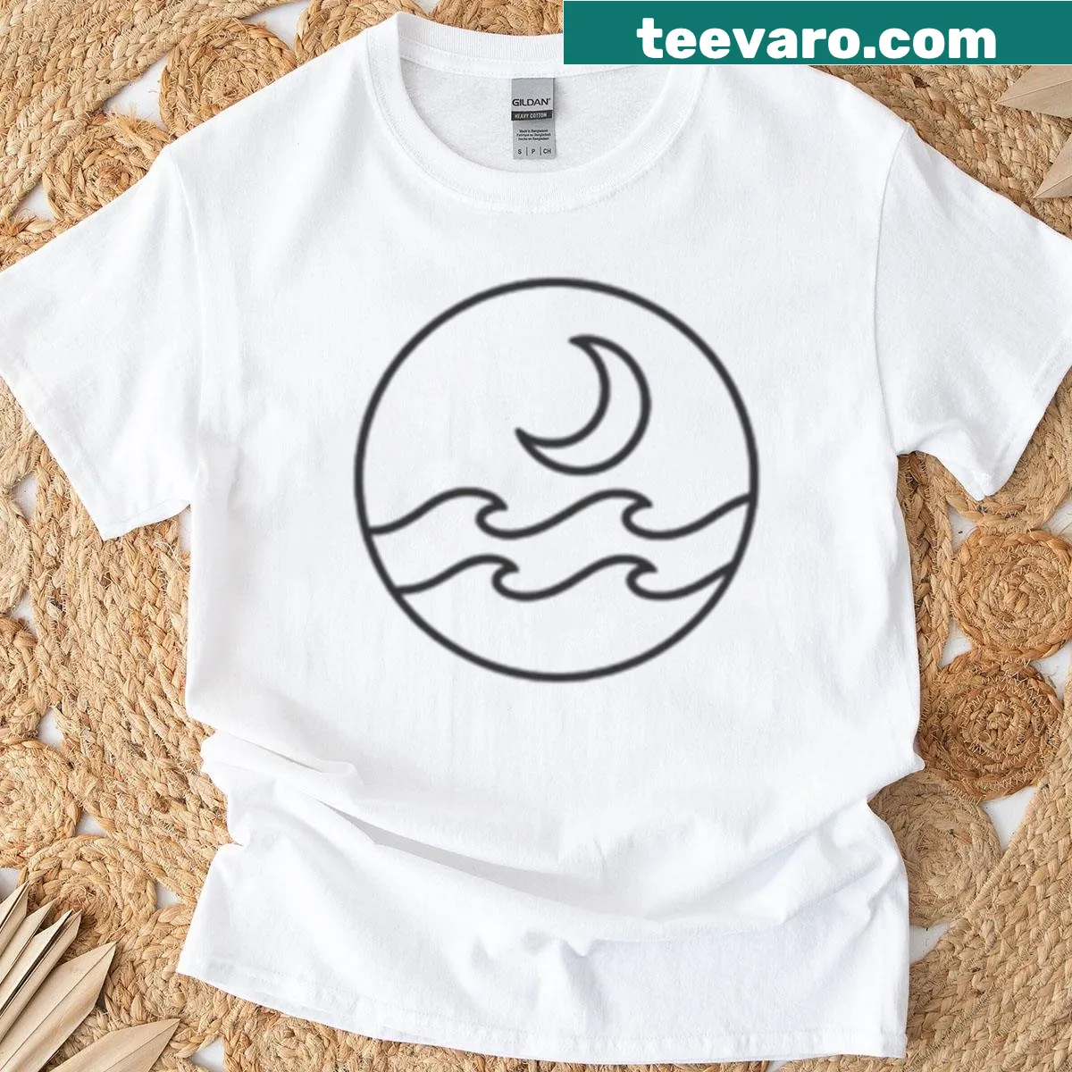T-shirt depicting a moon over calm ocean waves — on a men's t-shirt