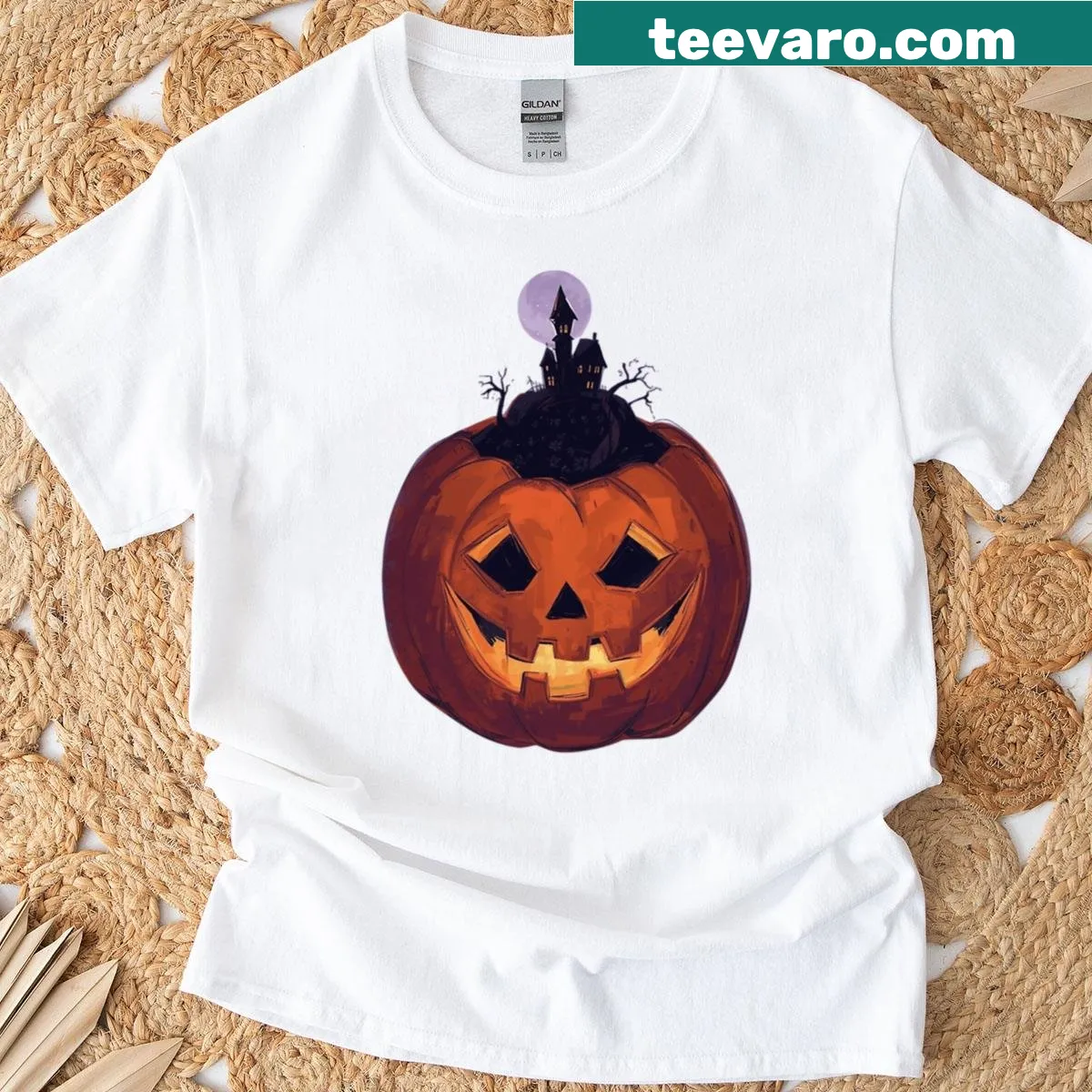Halloween-themed shirt with a jack-o'-lantern and haunted house illustration — on a men's t-shirt