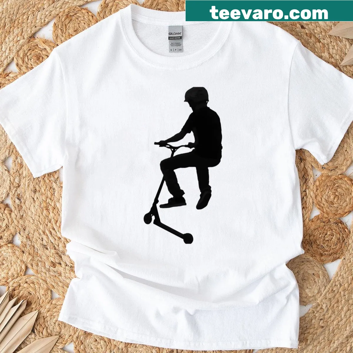 T-shirt featuring a cartoon graphic of a stunt scooter in mid-air — on a men's t-shirt