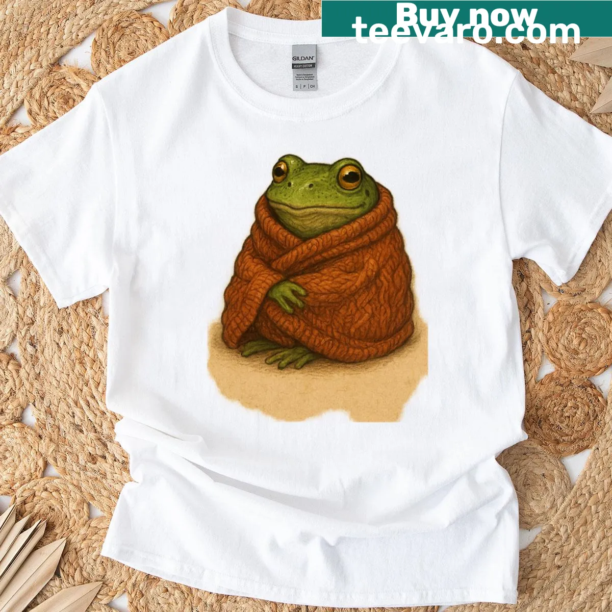 Cozy frog illustration wrapped in a knitted blanket on a T-shirt — on a men's t-shirt