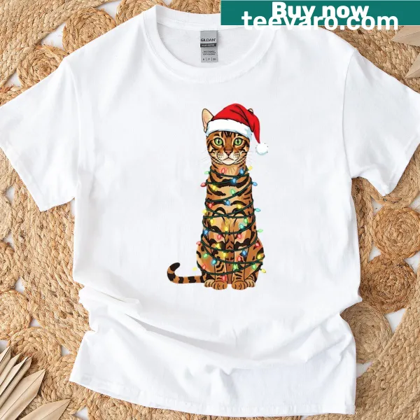 Bengal cat on Christmas tree wearing Santa hat