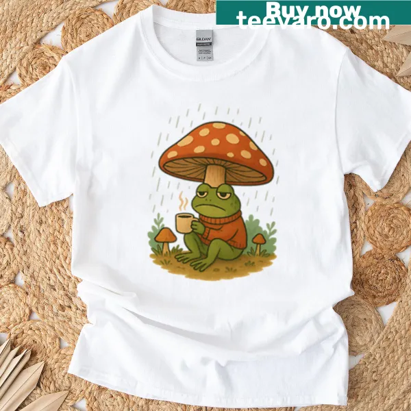 Illustrative t-shirt featuring a frog with coffee and mushrooms in the rain