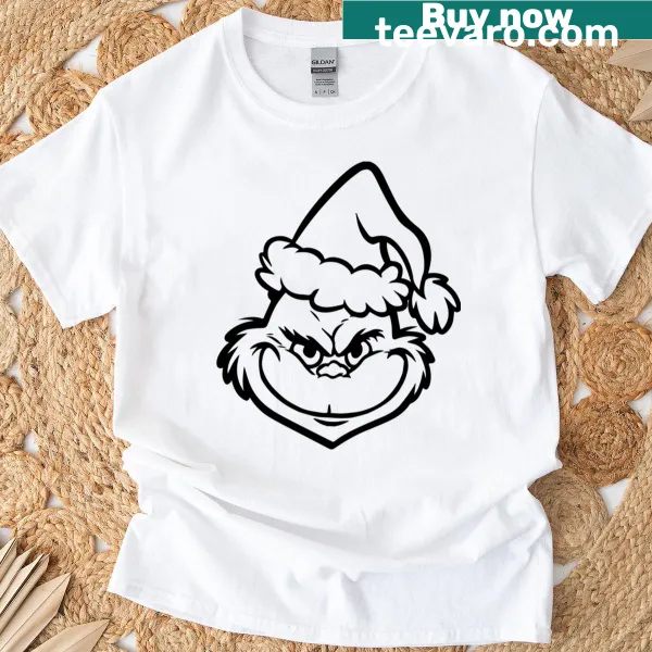 Christmas T-shirt featuring a playful Grinch face graphic