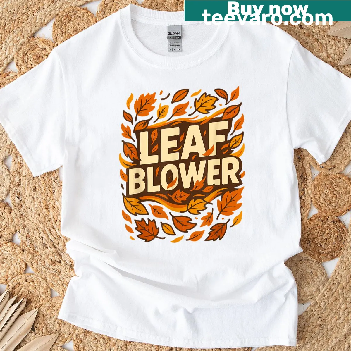 Vintage-style T-shirt with leaf blower and falling leaves graphic — on a men's t-shirt